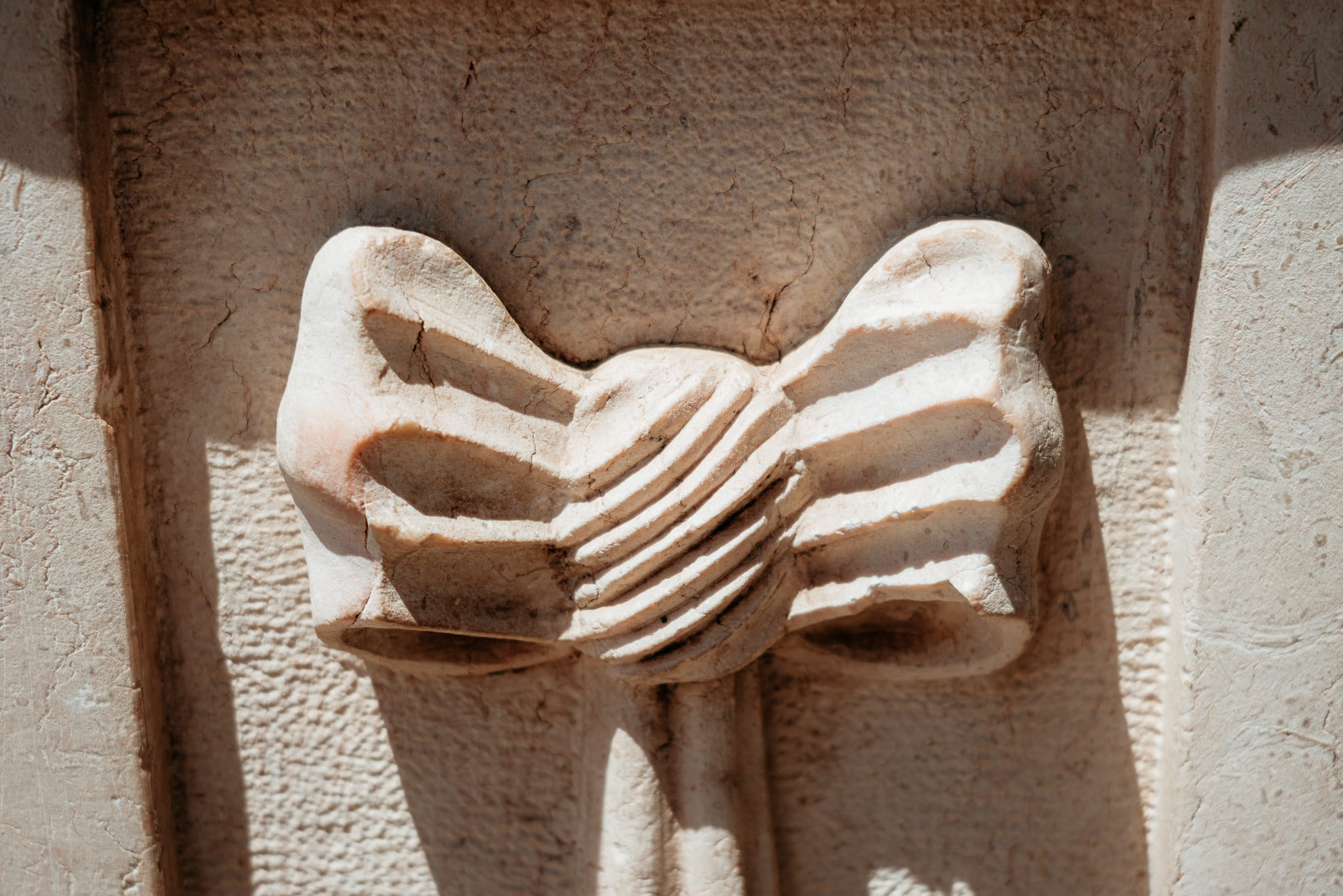 Close-up of stone carving resembling a bow.
