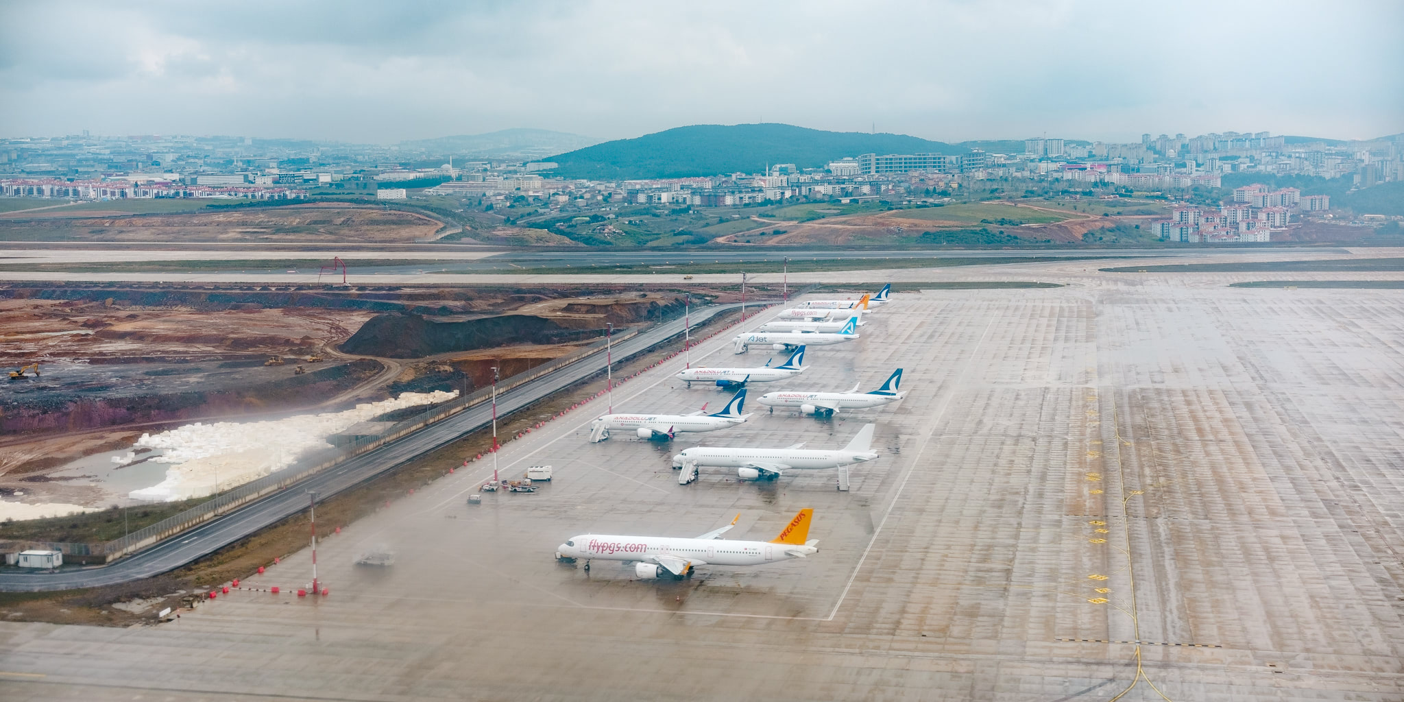 A row of parked airplanes at Istanbul Airport in Turkey.