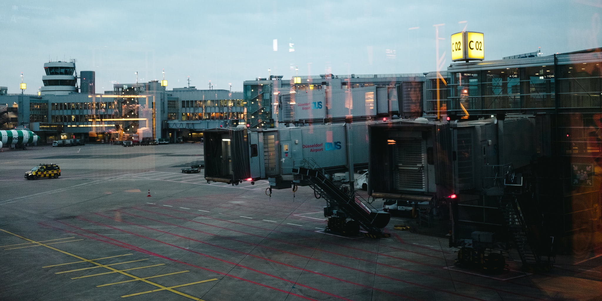 Airport terminal with jet bridges and control tower.