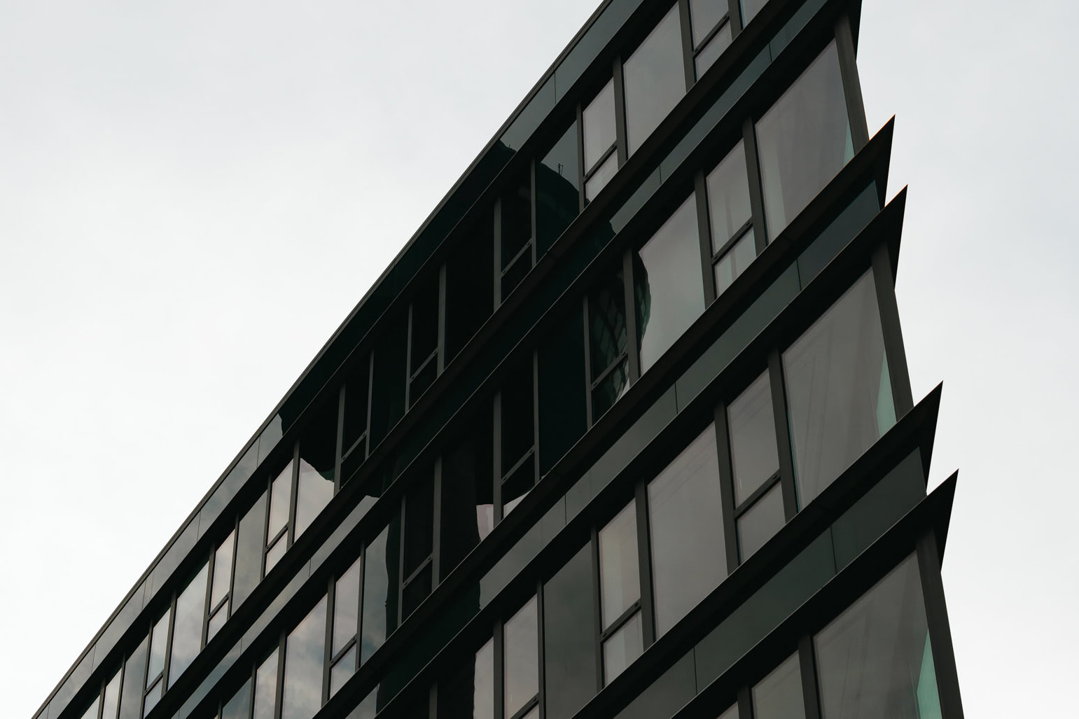 A modern building with sharp edges and glass windows.