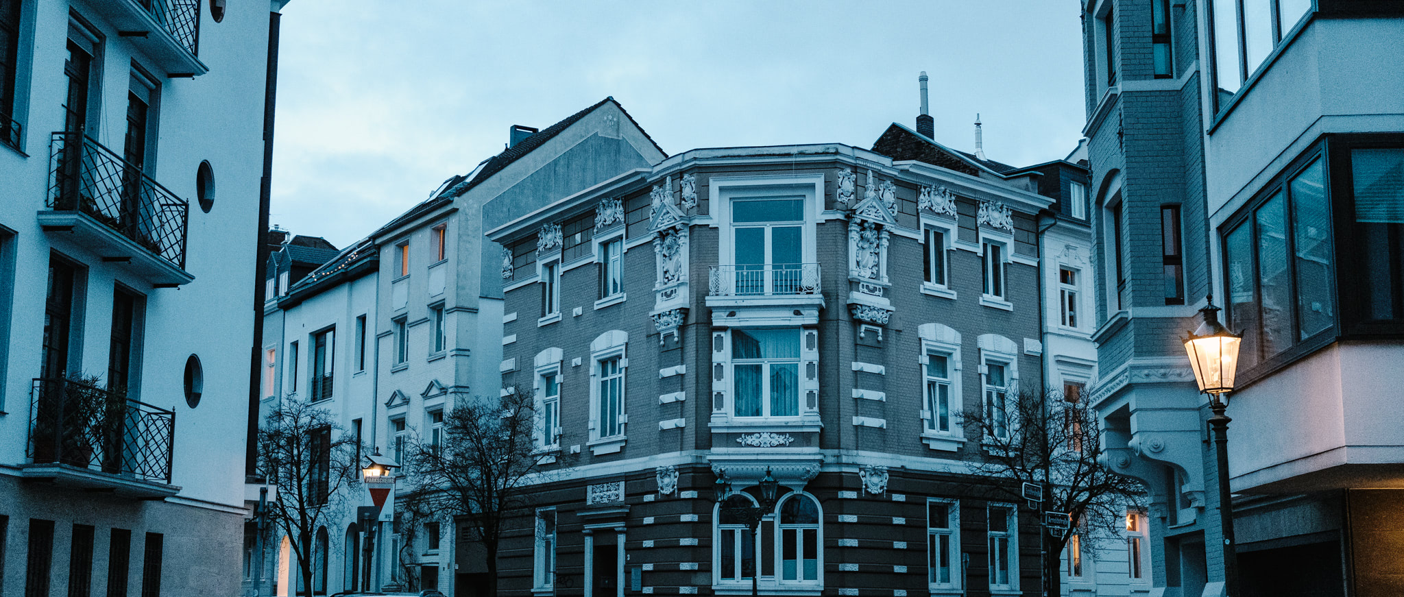 European corner building with ornate facade details on a cloudy day.