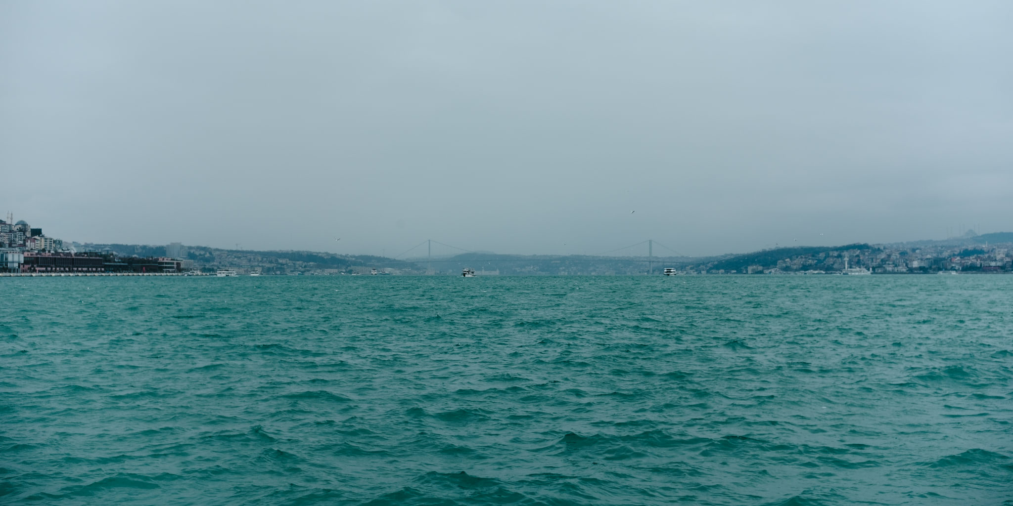 Sea view of the Bosphorus bridge in Istanbul on a cloudy day.