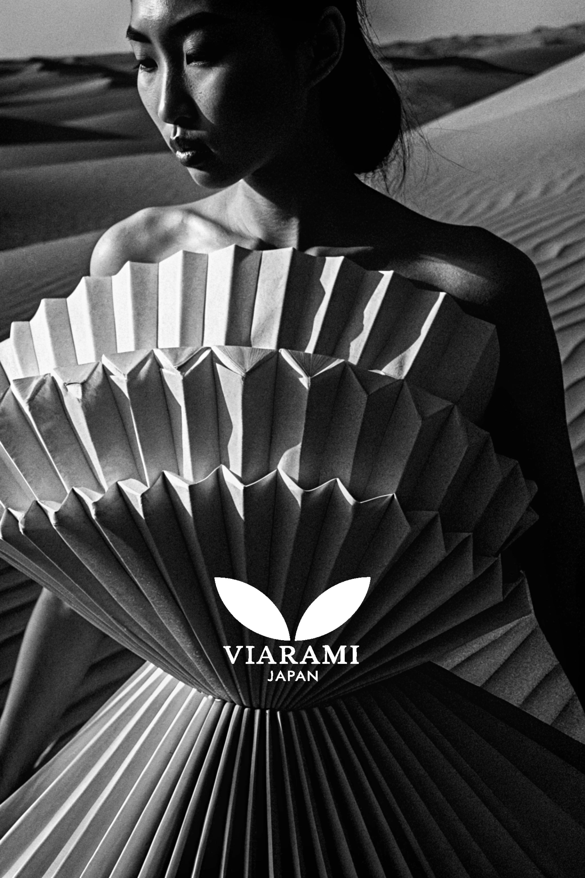 Woman in paper dress in the desert, black and white.