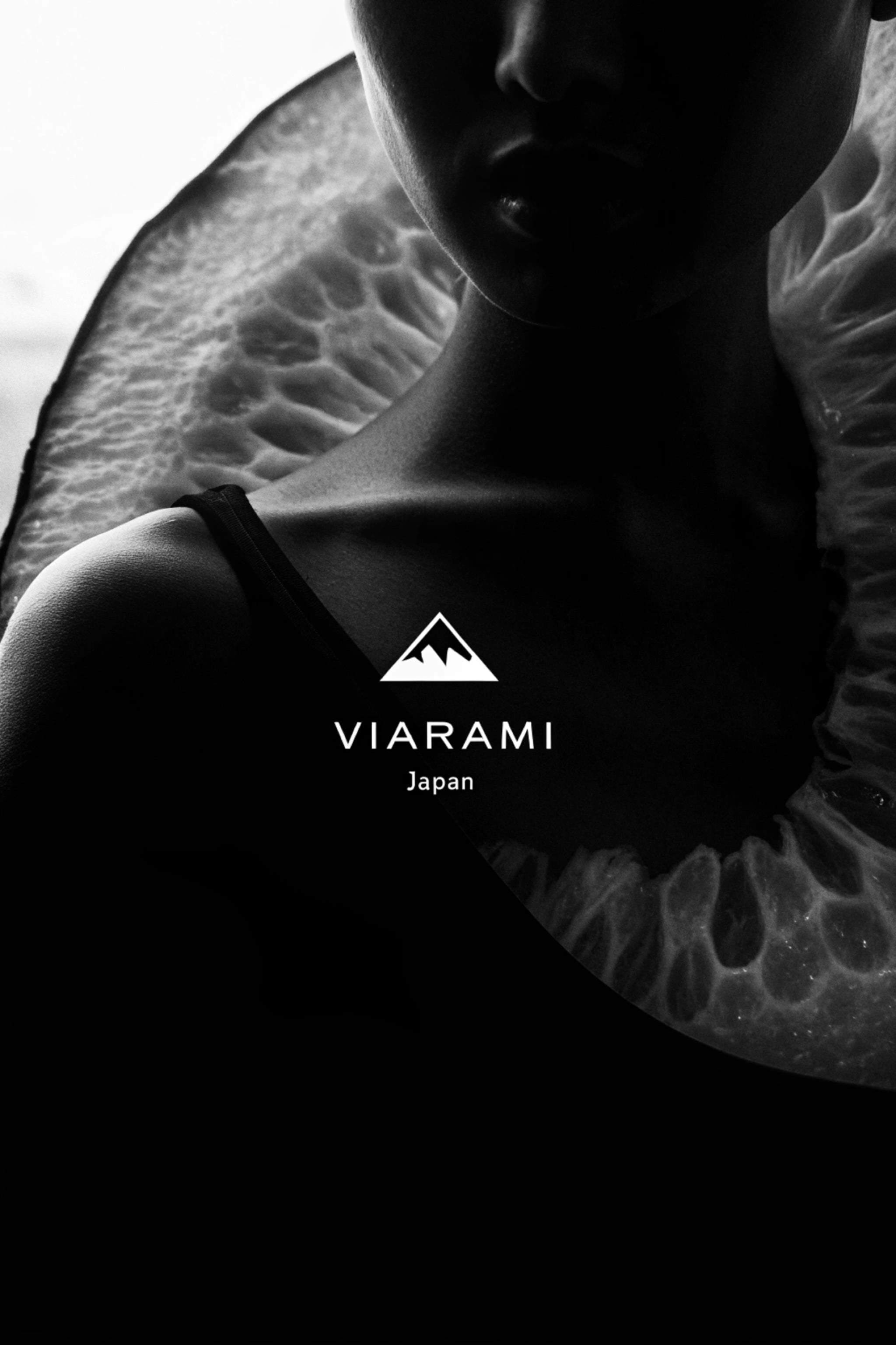 Black and white portrait of a woman with a citrus fruit.