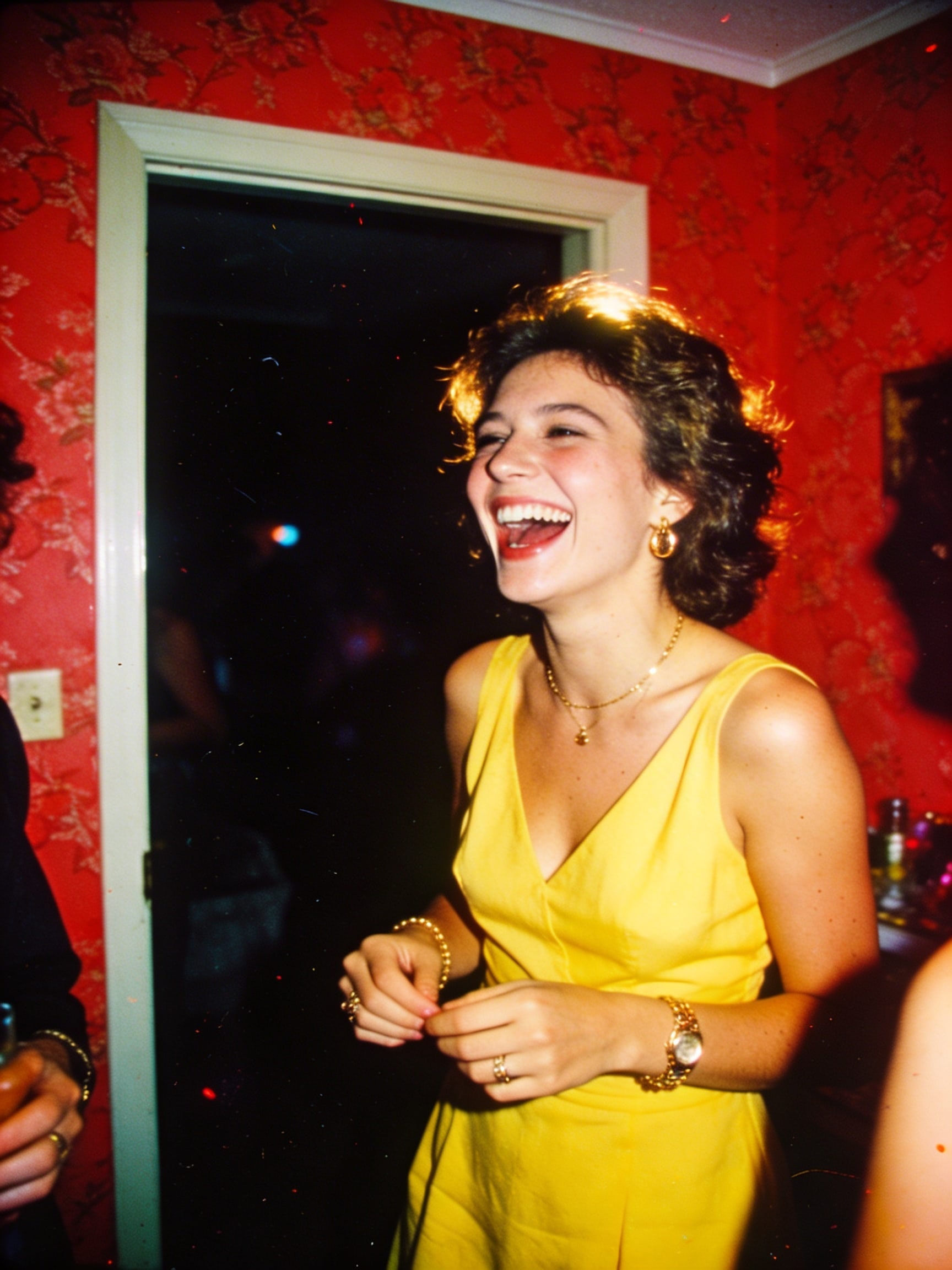 Portrait of a woman laughing at a party, lit by a harsh on-camera flash against red wallpaper.