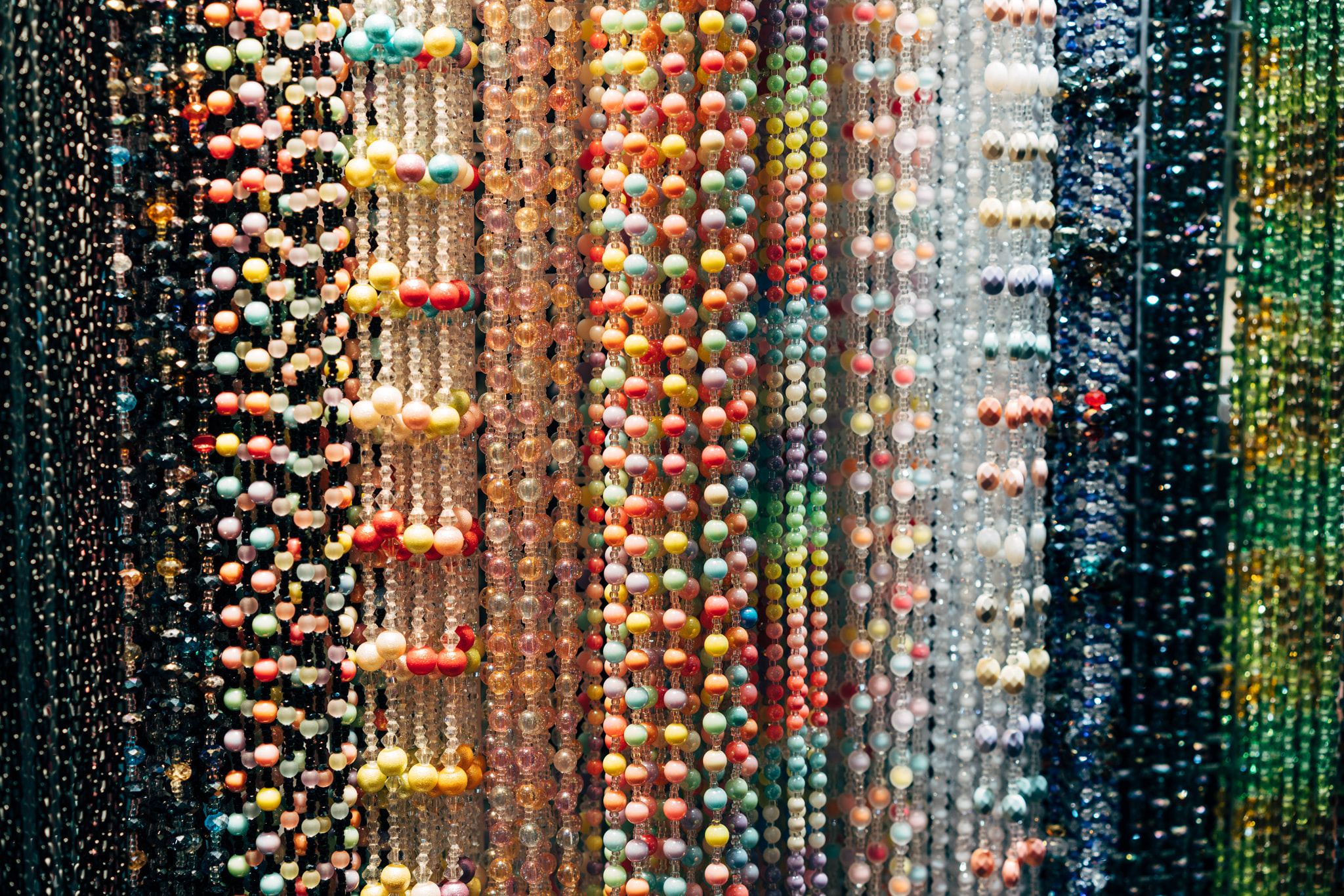 Colorful beaded curtains hanging in vibrant vertical strands