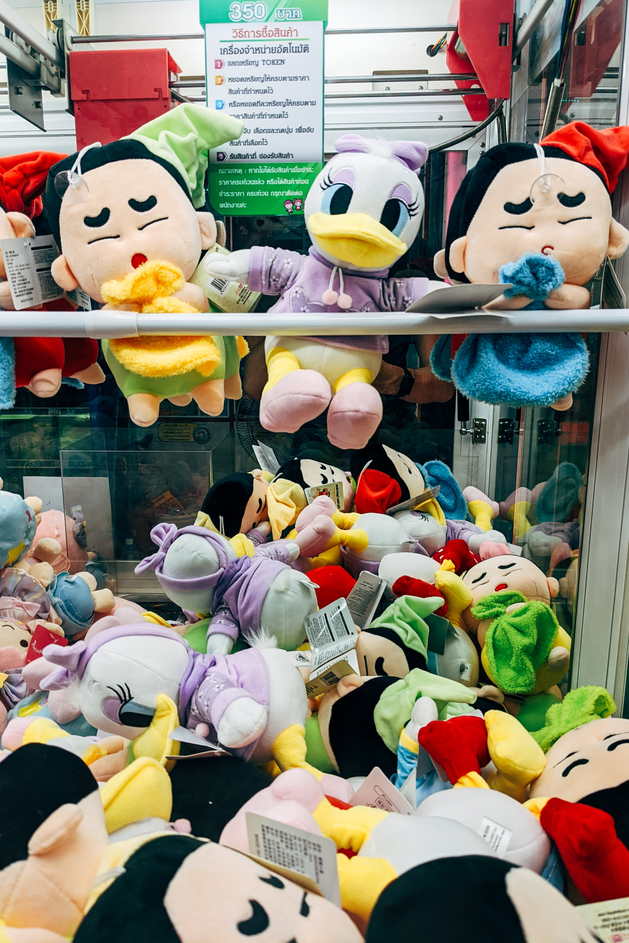 Plush toys including Disney characters in claw machine