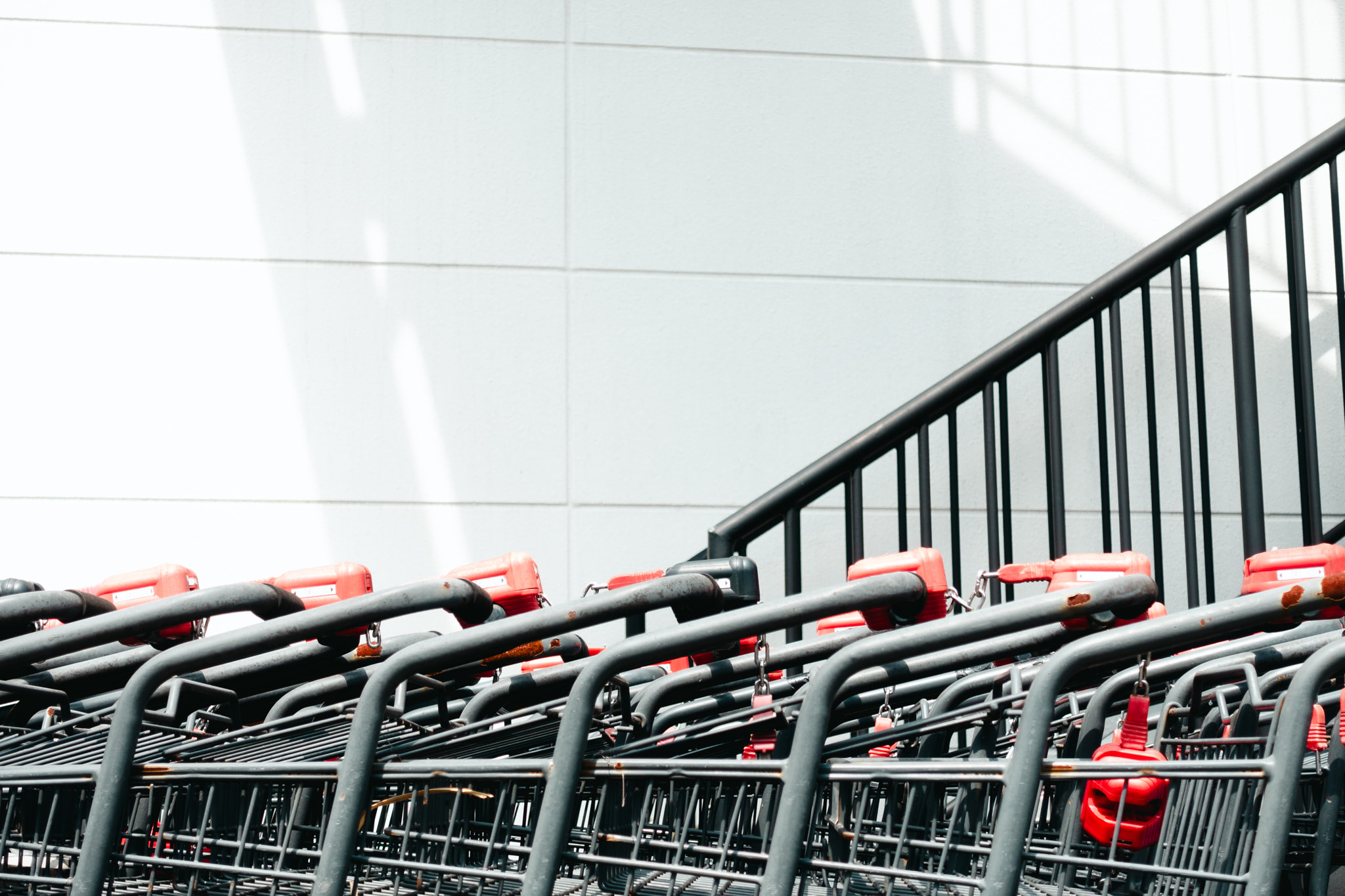 Row of shopping carts lined up outside a retail store