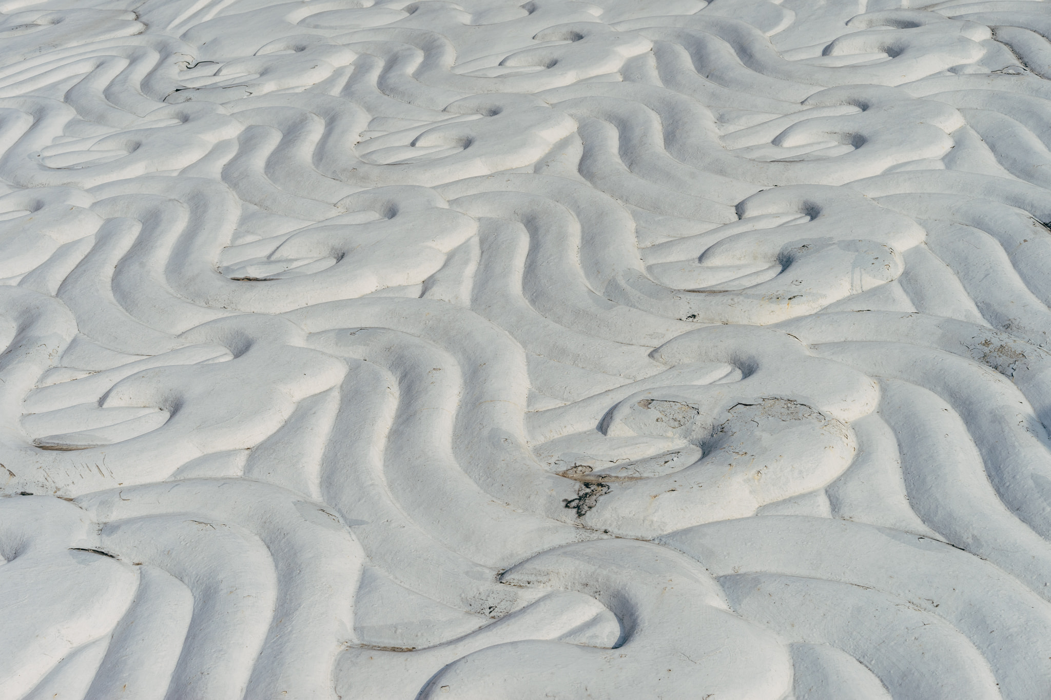 Snow covered ground with intricate wind-formed patterns