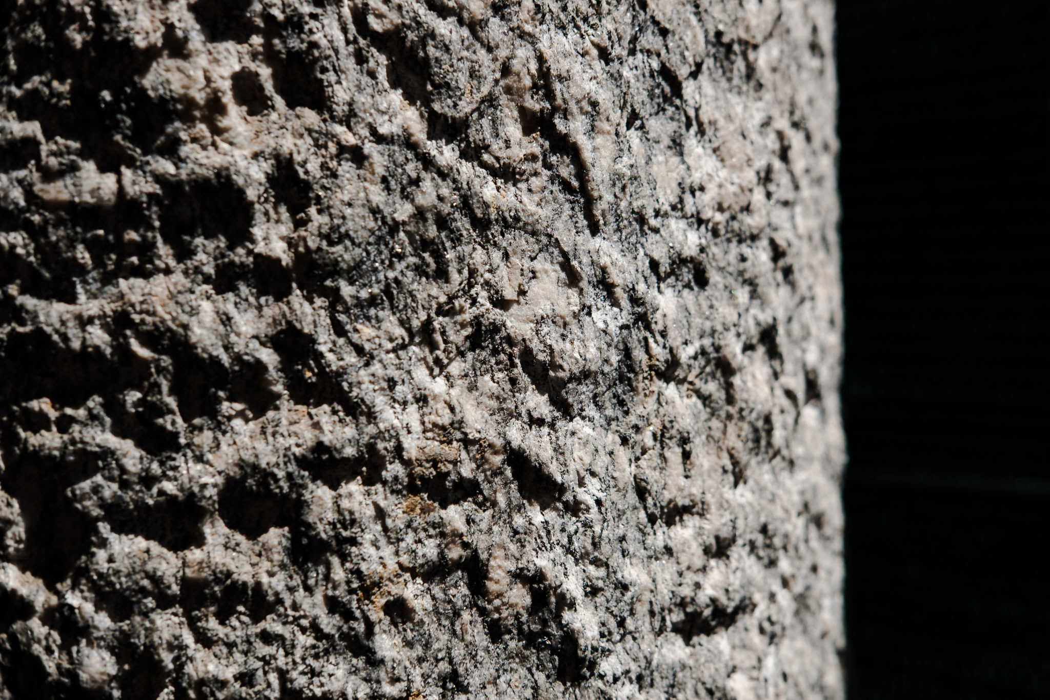 Close-up of weathered stone surface with rough texture