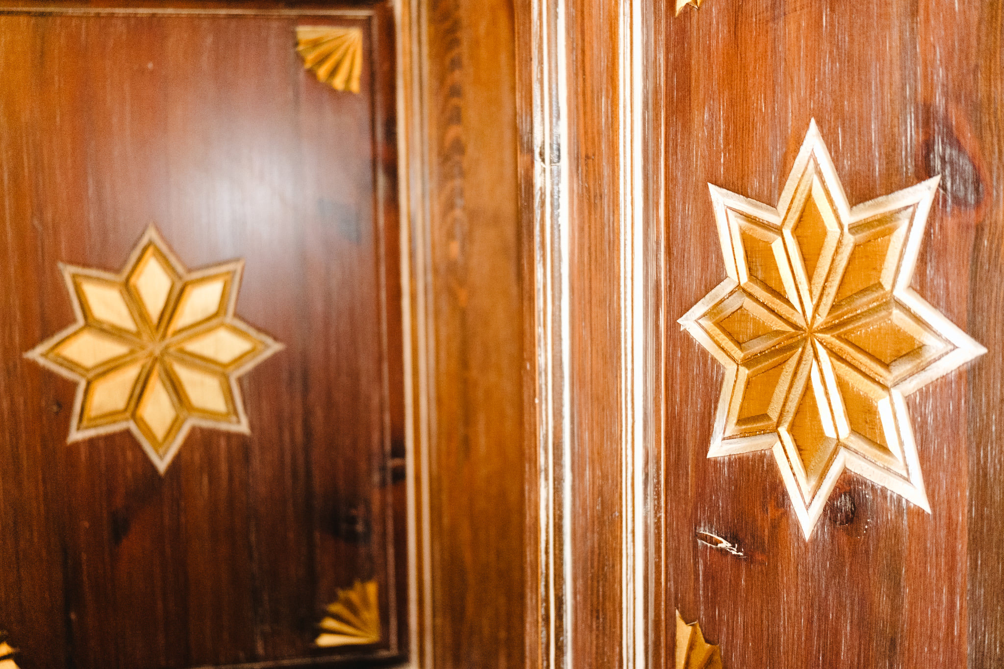 Ornate wooden door with carved star inlays