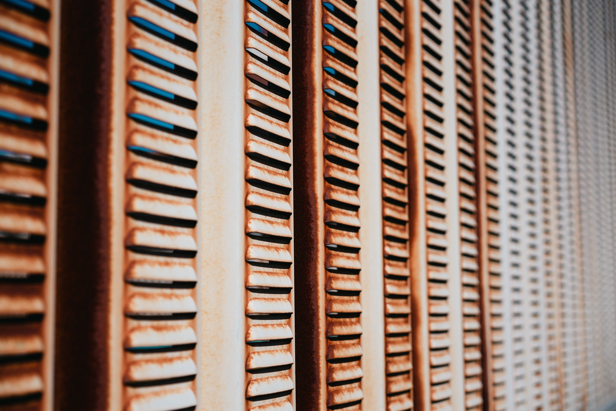 Close-up of vintage wooden louvered shutters with weathered finish