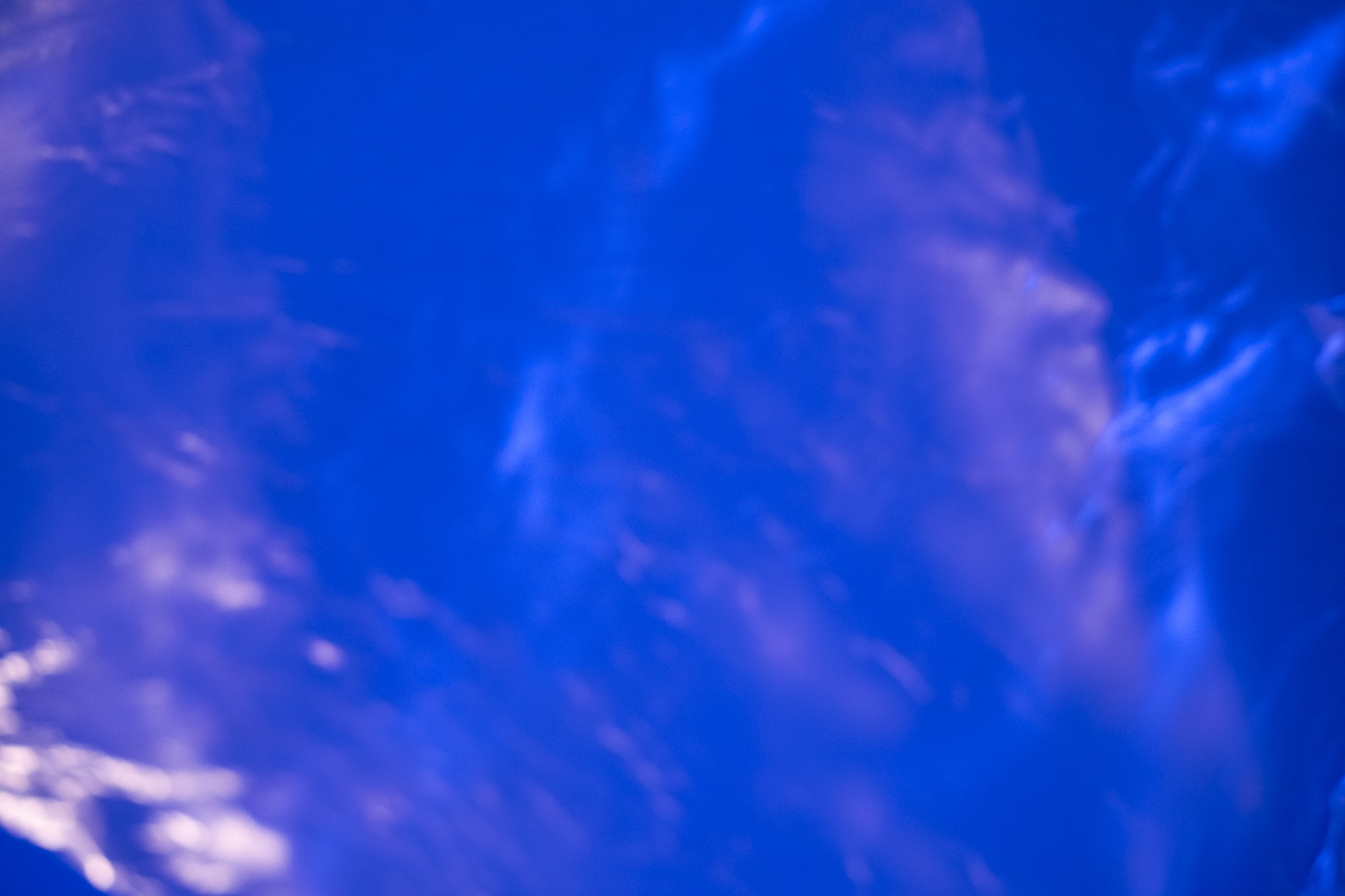 Abstract blue blurred background with purple light glow